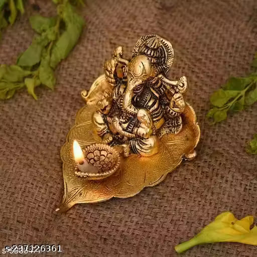 Ganesh Sitting On Pipal Leaf With Diya Metal Statue Home/Office/Decoration/Gifting Item Decorative Showpiece - 12 cm (Metal, Gold